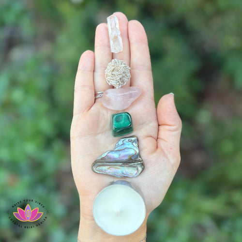 Reiki-infused Love and Self-Care crystal set with heart-healing stones, candle, and sage for compassion, emotional balance, and peace.